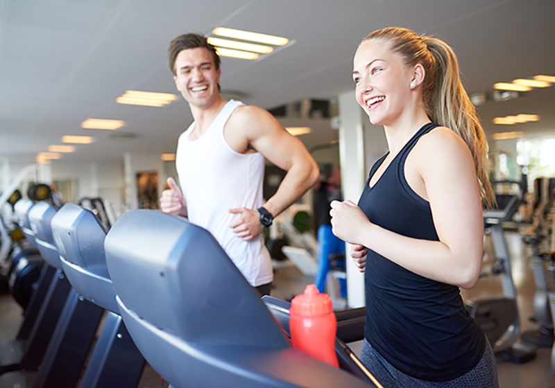 Couple running at gym using the Gym Reimbursement from Select Health