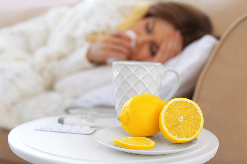 woman with a cold, laying down using remedies that ease cold symptoms