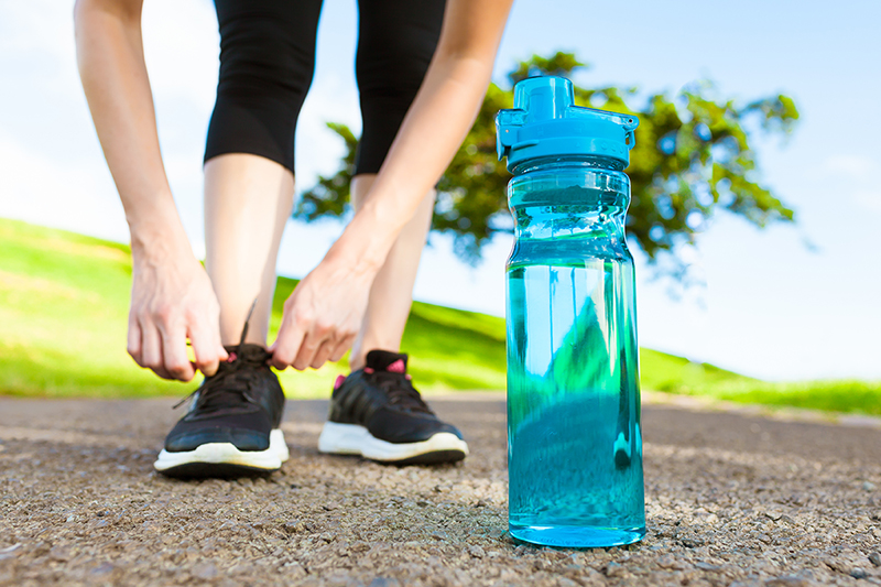 Building lasting health habits, woman and water bottle 