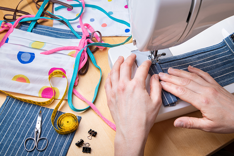 Woman sewing masks for COVID-19, how to help people in need