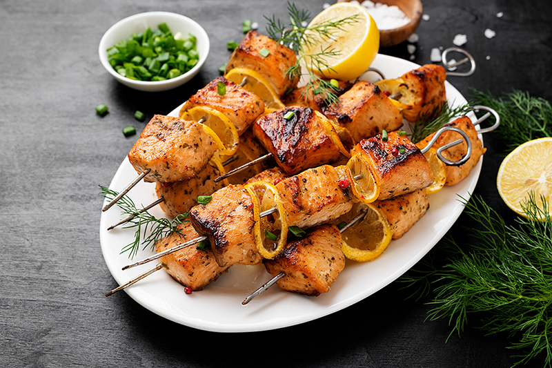 Salmon kebabs with lemon on a plate, recipe