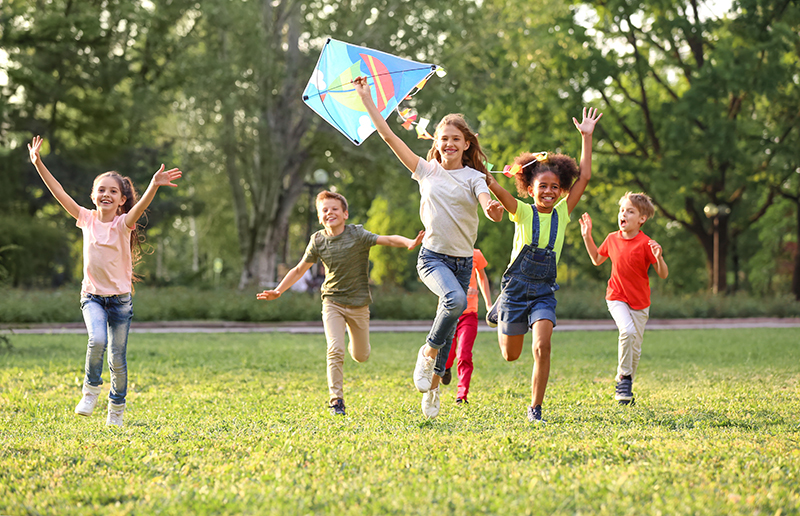 Kids running with kite, creative ways to keep kids active during social isolation, lg