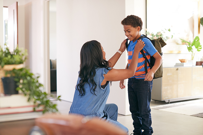 Mom helping her son get ready for school, helping your family navigate change