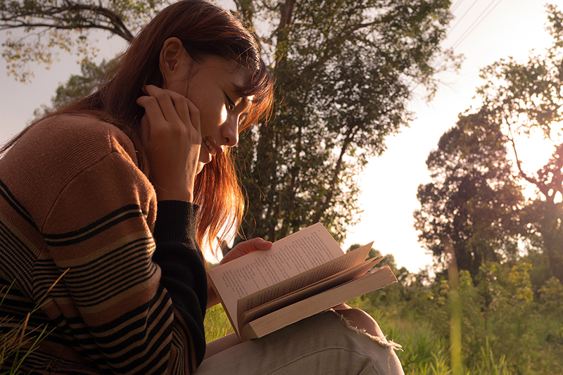 women reading outside, practicing self-care tips for a healthy mind and body