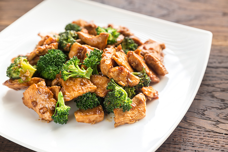 Chicken and broccoli stir fry on a white plate, recipe