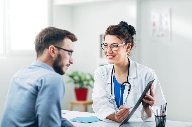 Man at the doctor staying healthy by having preventive care