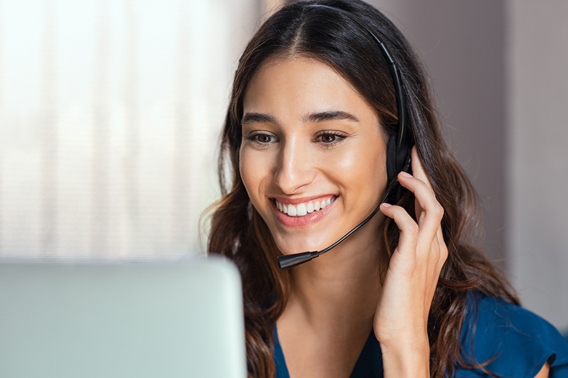 Woman on the phone in front of computer, how care management can help lg