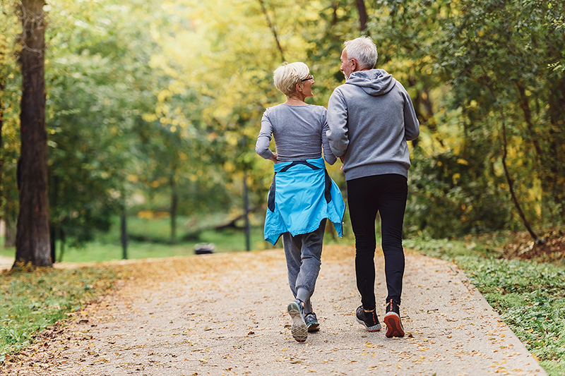 Couple walking outside, exercises to boost your immune system, fb