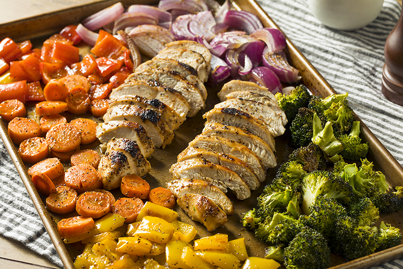 Sheet-pan chicken and veggies on a table, recipe