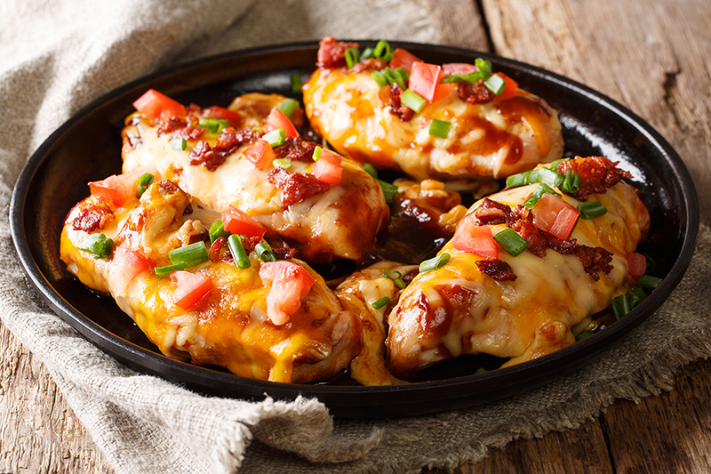 A plate of slow cooker salsa chicken topped with Mexican cheese.
