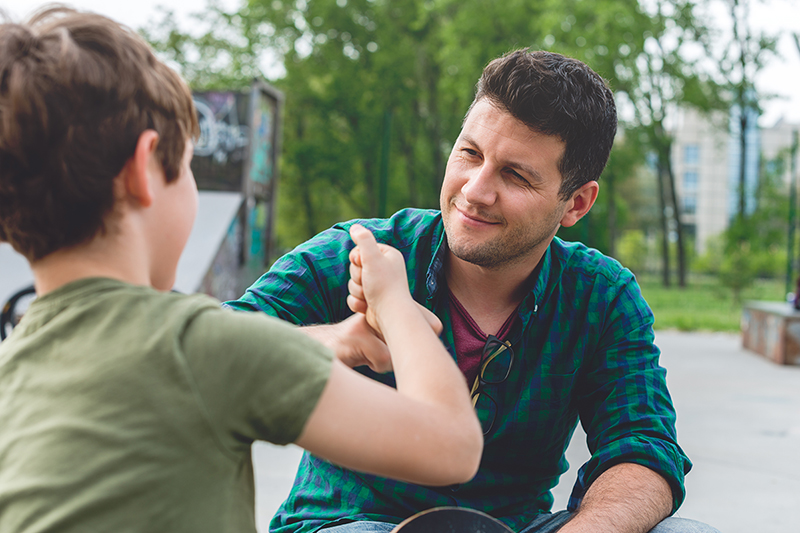 Father and son fist bump after talking about the dangers of smoking and vaping.