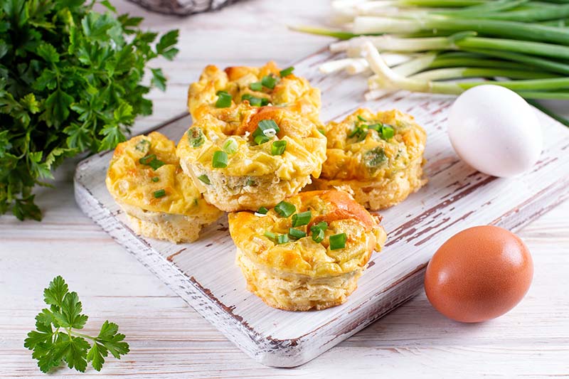 Freshly made egg bites on a wooden cutting board.