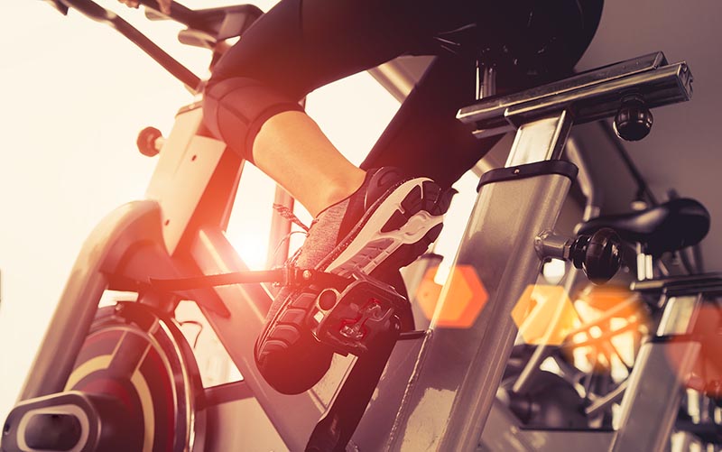 Woman cycling for her cardio workout.