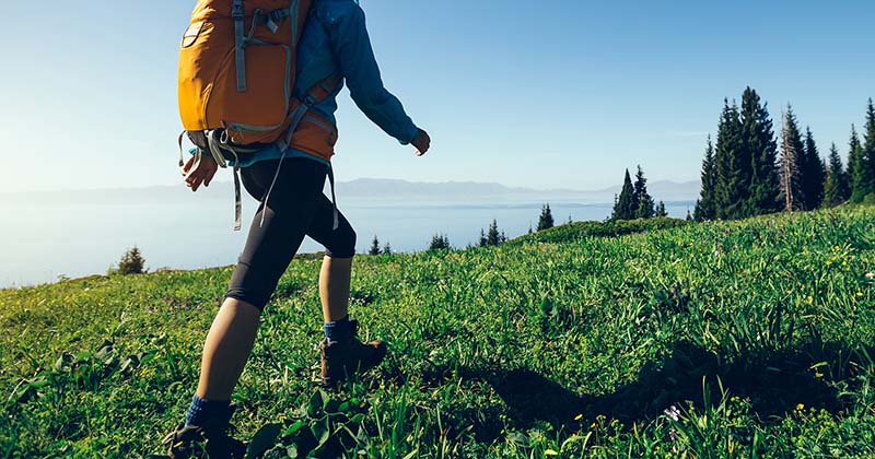 Woman hikes mountain for her outdoor exercise.