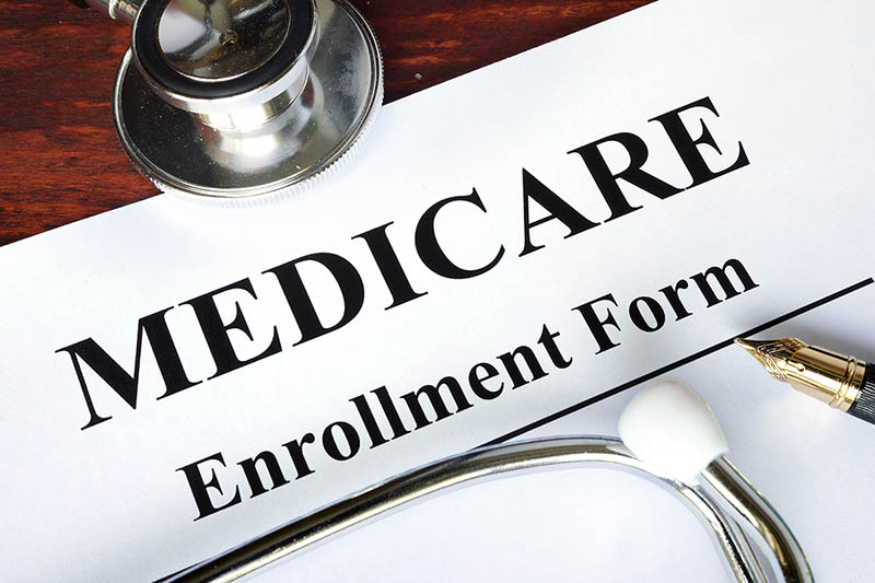 Medicare enrollment form on table with pen.