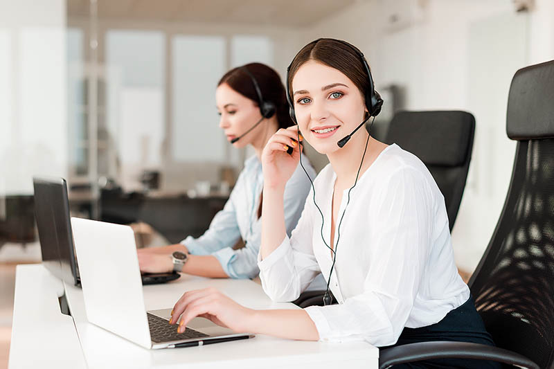 Young care manager helping member on the phone.