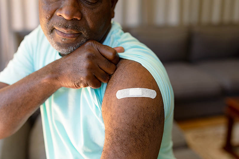 Older man gets the flu vaccine.