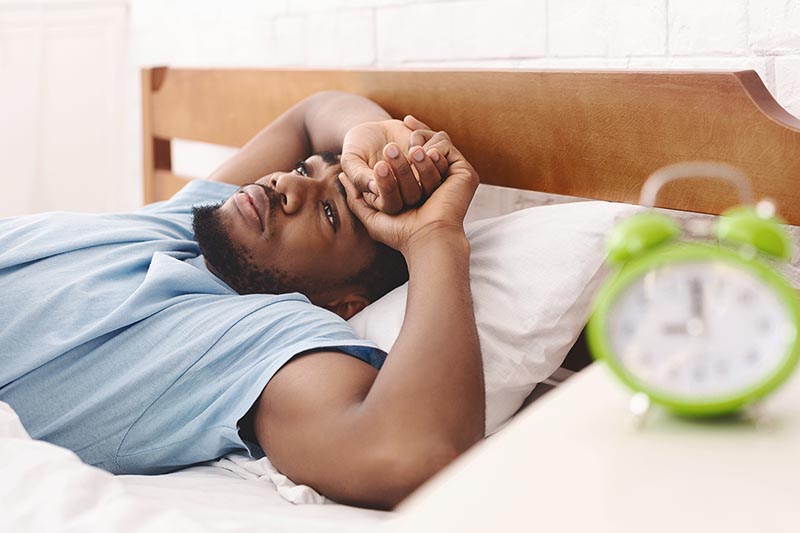 Man has trouble sleeping because of sleep apnea.
