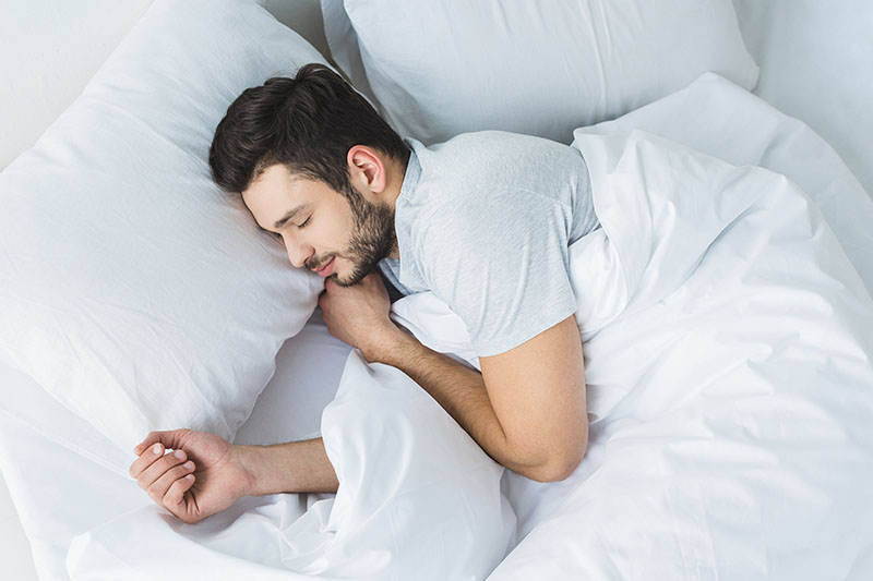 Young Man Sleeping Pillow Legs Which Keeps His Pelvis Neutral