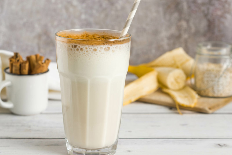 Creamy Tahini Date Banana Shake with cinnamon on top.