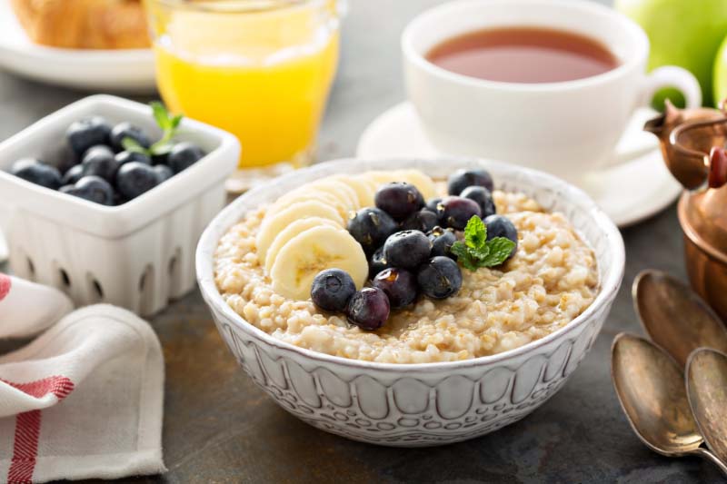 Bowl of steel-cut oats with blueberries and bananas.