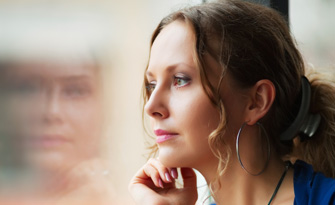 Girl leaning against window