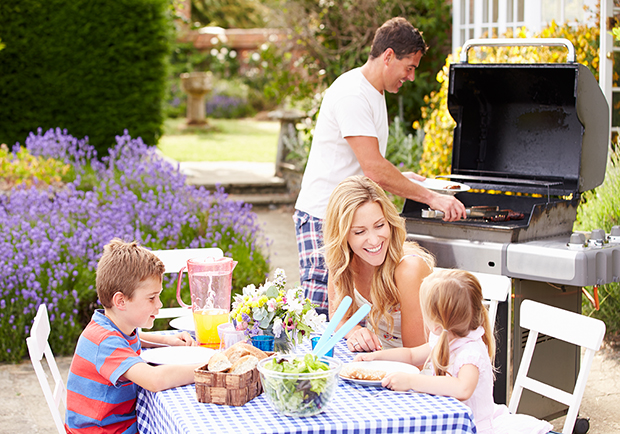 Family outside during the summer having an outdoor barbecue