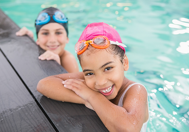 Two children swimming in the pool, water safety tips. Stay safe around water. 