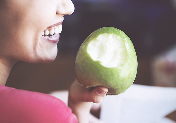 Trick your body into feeling full, lady eating an apple