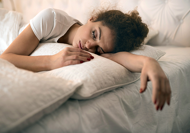 Which sleep position is best for you? Side? Back? Stomach? Lady sleeping on her side. 