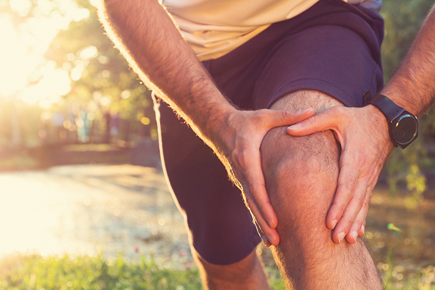 Man stretching. Use these stretches to help protect your knees from injury