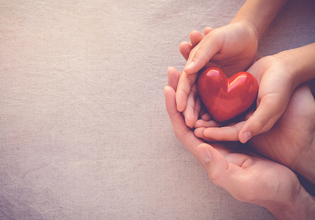 Hands holding a heart, random acts of kindness are great for mental health and overall wellness