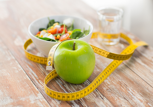 Shave 100 calories a day, apple, tape measure and water