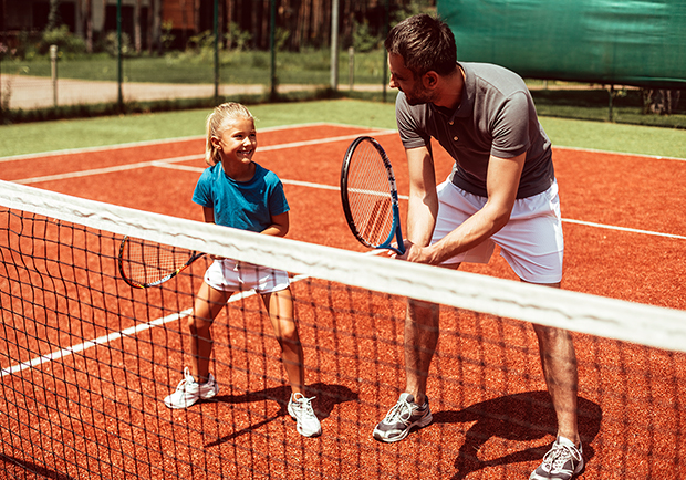 Dad and daughter playing tennis. Workouts to get you ready for summer