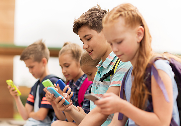 Kids playing with their phones, is your child ready for a smartphone? 