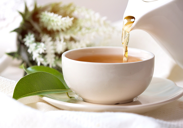 Pouring tea into a tea cup, there are many benefits to drinking tea