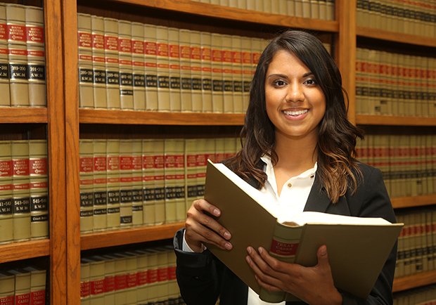 woman standing in front of law books, how I got into law school, large