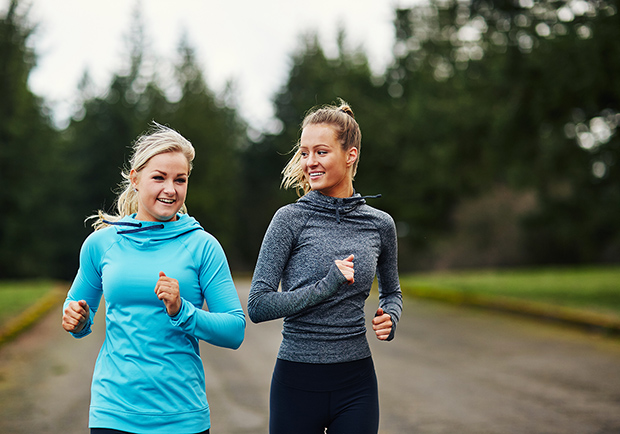 Two friends, ladies working out together. What are the benefits to having a workout buddy? Large