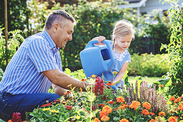 Man and daughter gardening outside for health fb