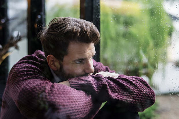 man staring out window, signs and symptoms of suicide lg