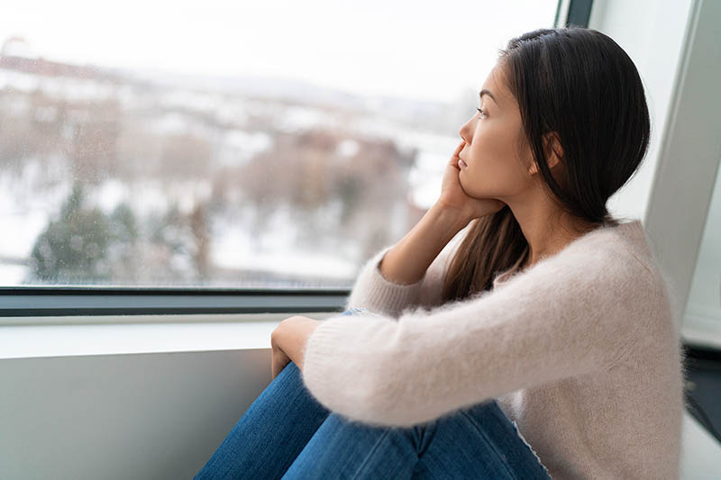 A woman experiencing depression or Seasonal Affective Disorder during Winter