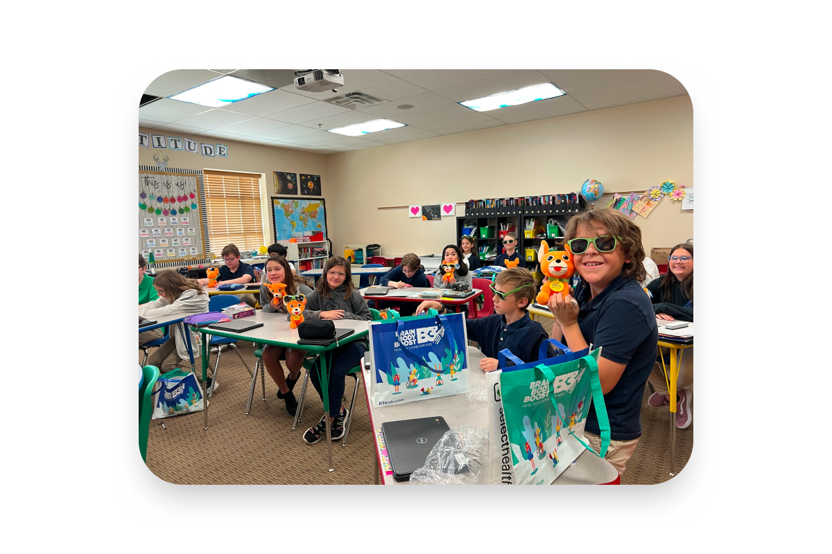  class with teacher at desks holding stuffed dogs wearing glasses