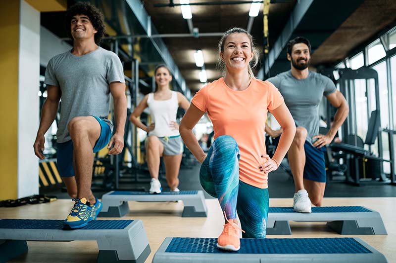 Group having fun at a gym fitness class.