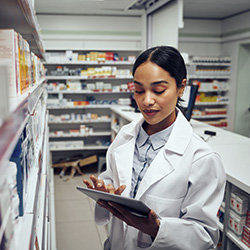 Pharmacist using a tablet in a pharmacy