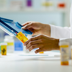 Pharmacist filling a pill bottle