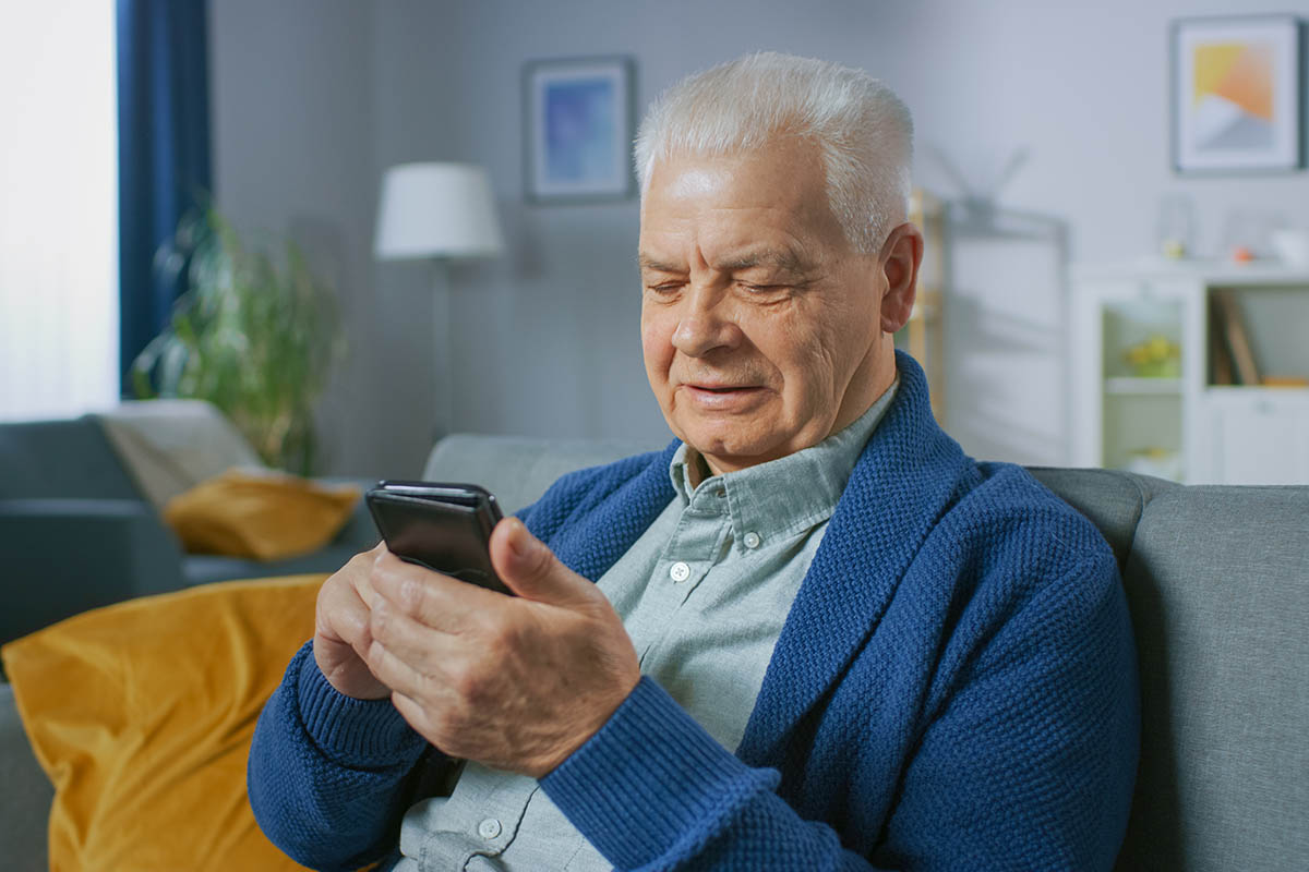 Man on a couch looking at his phone